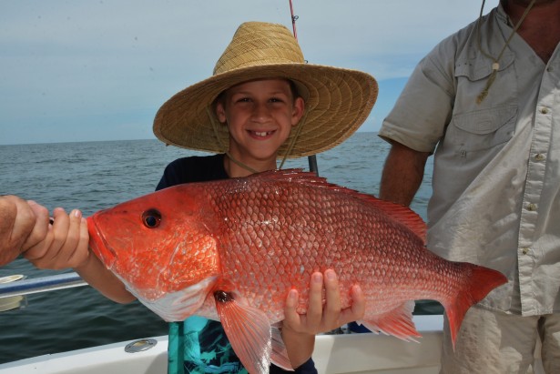 child-holding-red-snapper-fish