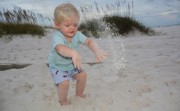 photograph-kid-throwing-sand-on-the-beach