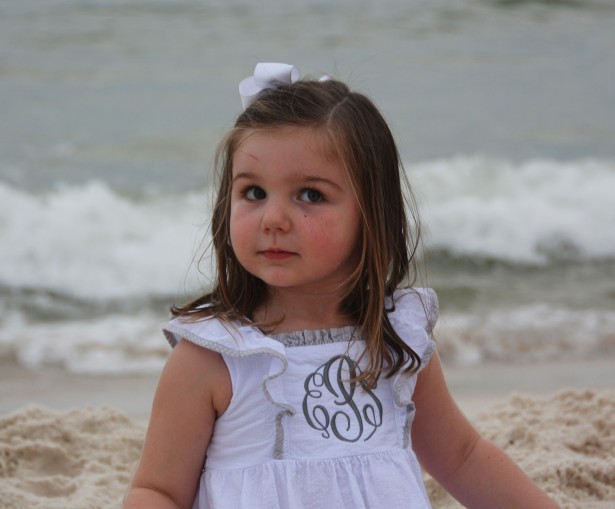 girl-on-beach-cutting-eyes-at-parents-during-beach-photography-shoot