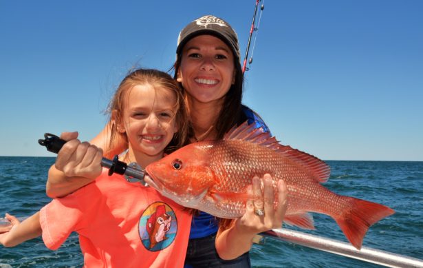 mom-daughter-holding-red-snapper