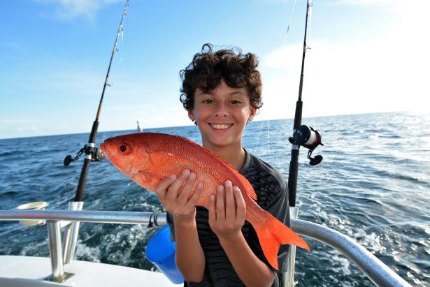 boy holding vermilion snapper