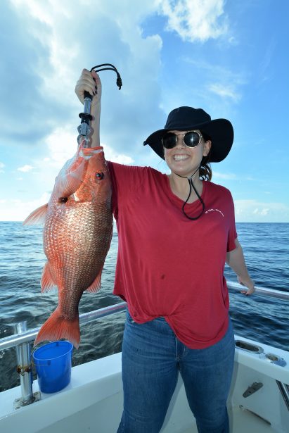 girl-holding-red-snapper-fish