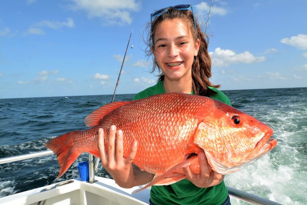 girl-holding-red-snapper-fish