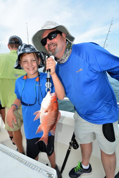 grandpa-grandson-fishing-holding-red-snapper